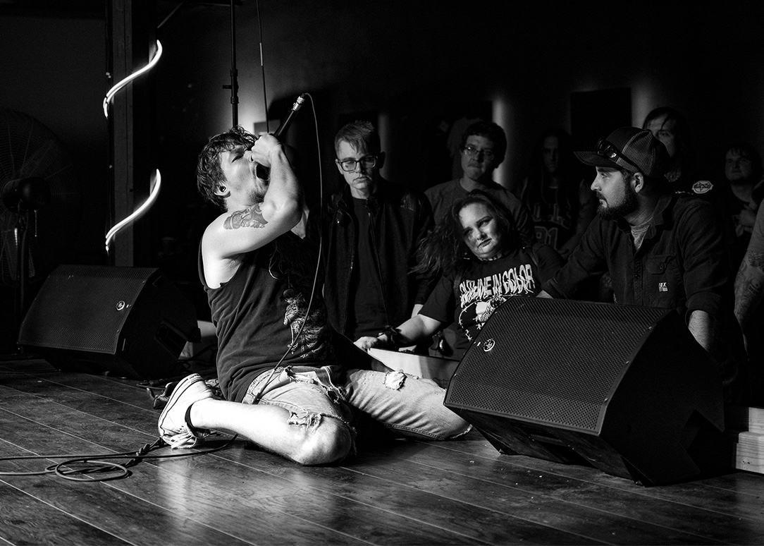 Vocalist performing live in black and white
